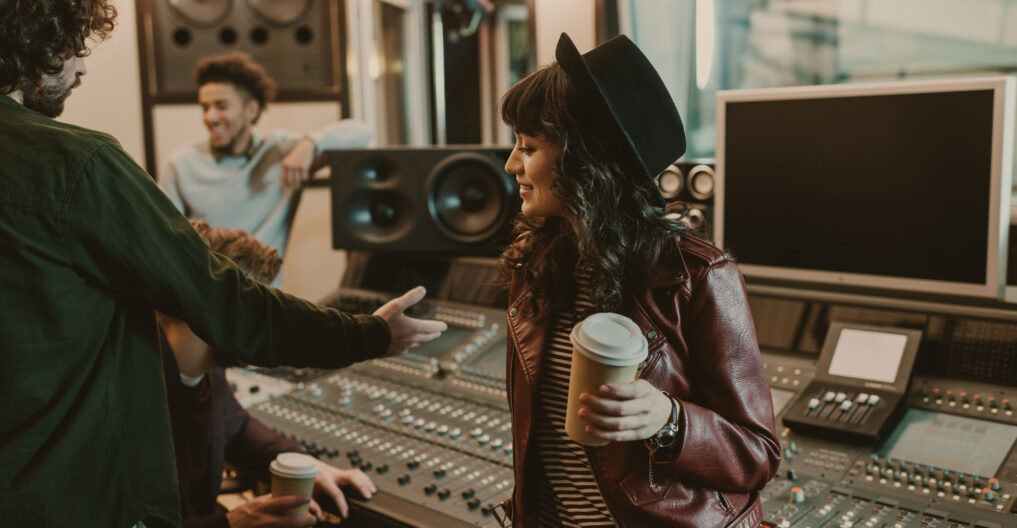 group of young musicians spending time at recording studio